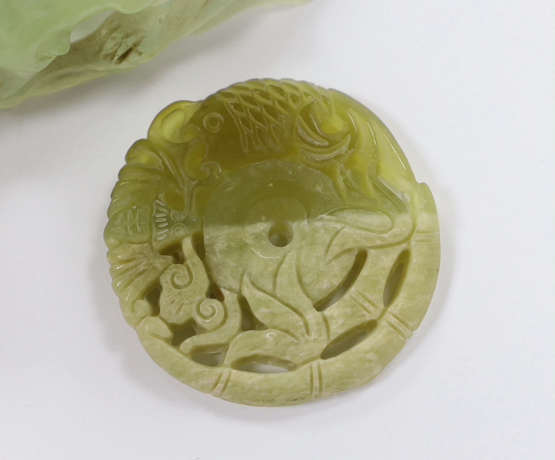 A collection of Chinese jades, etc including a carved disc, largest 11cm wide